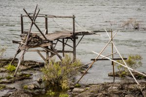 USA: Oregon, Columbia River Basin, The Dalles (former site of Celilo Falls, before The Dalles Dam), by bridge to Washington, traditional wooden platforms used by local tribal Indians for salmon fishing