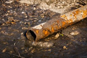 USA:  Louisiana, the Atchafalaya Basin, rusted and abandoned oil-waste discharge pipes (owned by A. Wilberts Sons, LLC, a Texas family oil partnership) polluting waters of  "Shell Beach (traditional Native American feast location)