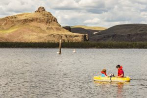 USA:  Washington, Columbia and Snake River Basins, Lyons Ferry, confluence of the Snake and Palouse Rivers, Lyons Ferry Park on the Palouse River Estuary, called Lake Herbert G. West, boys boating in rubber canoe, MR