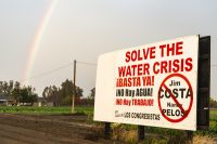 USA:  California, Central Valley, Rainbow near Dos Palos on Rt 152 and sign about Water Costa