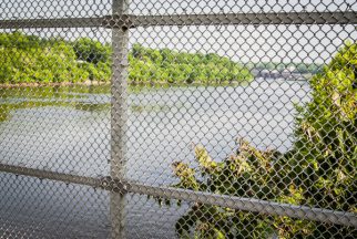 USA:  New Jersey, New Brunswick, Albany Street Bridge, view east of the Raritan River through chain link fencing of bridge