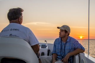 USA: New Jersey, Raritan River Basin, No Water No Life expedition, Raritan Bay sunset cruise, Bill Shultz (Raritan Riverkeeper) discussing Raritan Bay management issues with intern.